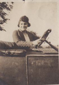 Woman from early 1900s driving car