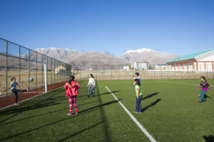 Young Turkish girl plays football with the guys